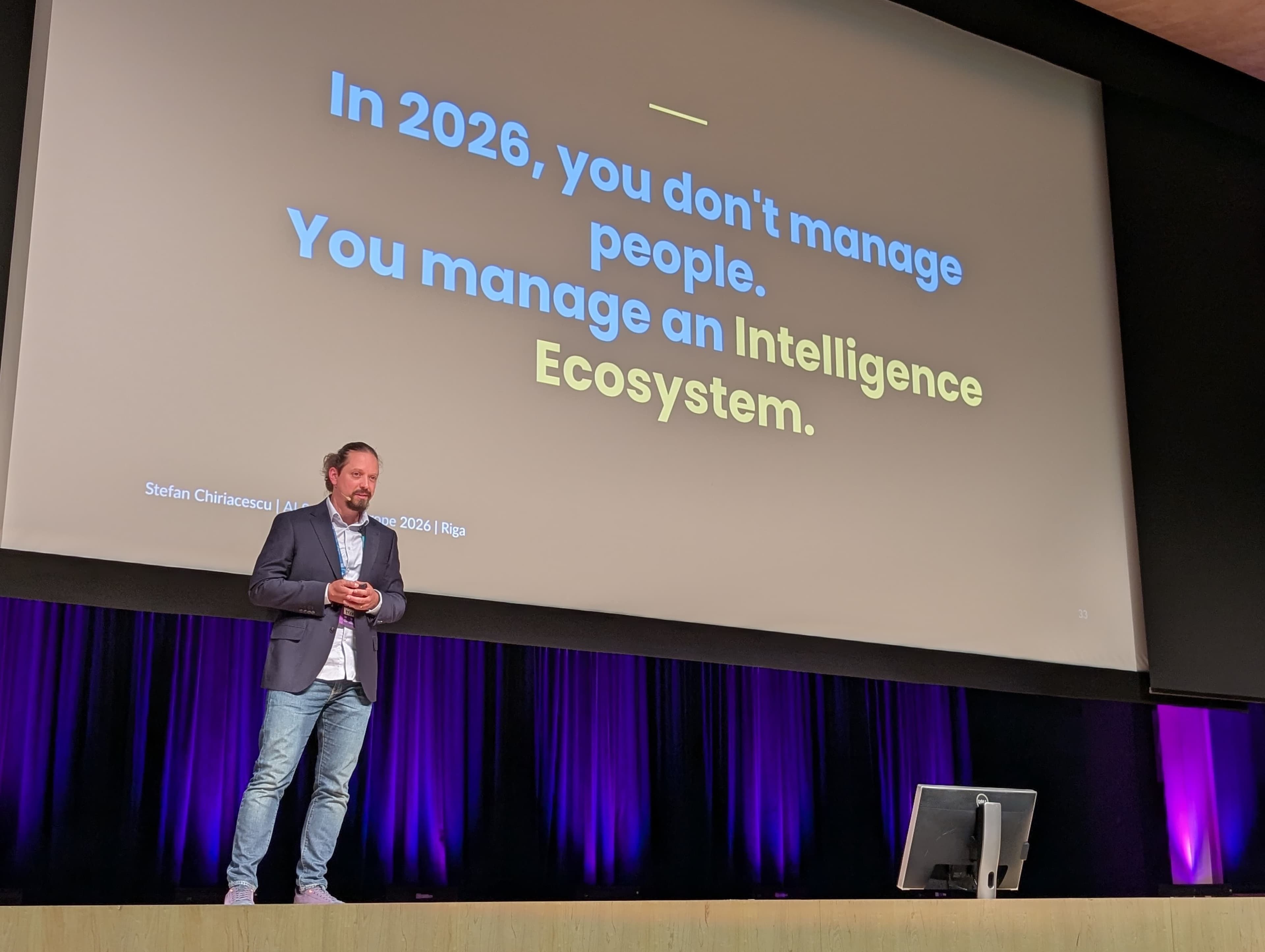 Stefan Chiriacescu delivering the keynote at AI Summit Europe 2026 in Riga.